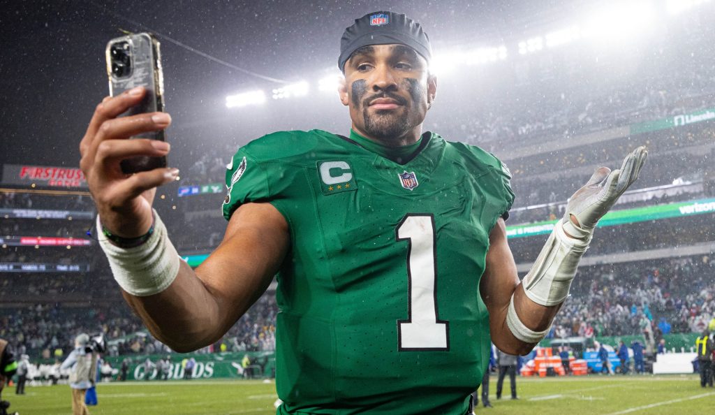 Nov 26, 2023; Philadelphia, Pennsylvania, USA; Philadelphia Eagles quarterback Jalen Hurts (1) reacts with a smart phone while walking off the field after an overtime victory against the Buffalo Bills at Lincoln Financial Field. Mandatory Credit: Bill Streicher-USA TODAY Sports