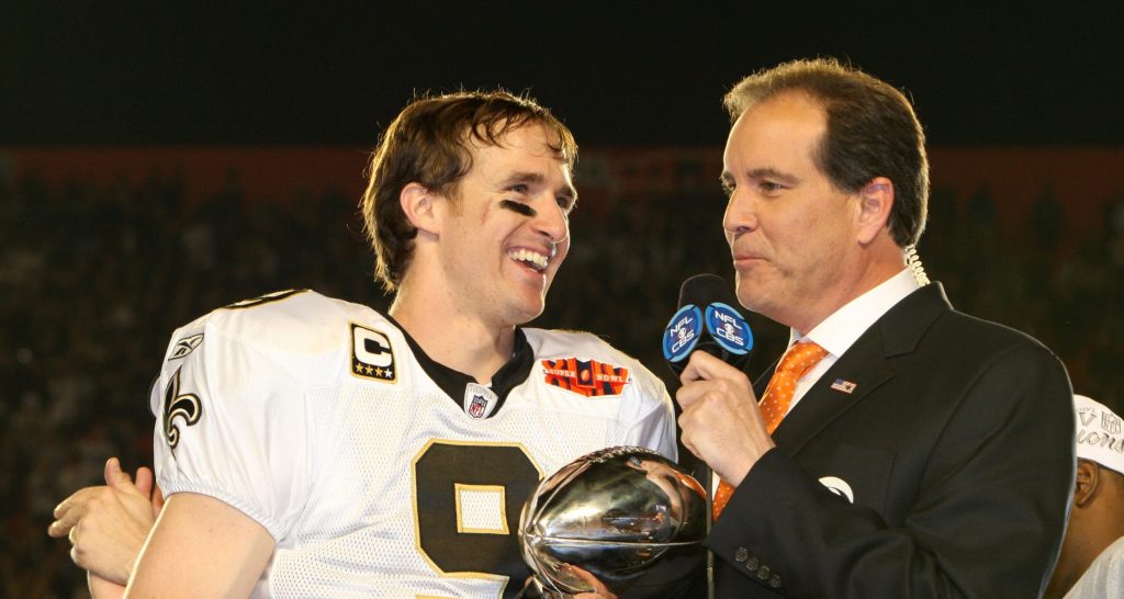 Feb 7, 2010; Miami, FL, USA; New Orleans Saints quarterback Drew Brees (9) holds the Lombardi Trophy and talks to CBS broadcaster Jim Nantz after defeating the Indianapolis Colts 31-17 in Super Bowl XLIV at Sun Life Stadium.