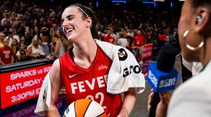 Indiana Fever guard Caitlin Clark (22) smiles in an interview after becoming the first rookie to have a triple-double Saturday, July 6, 2024, during the game at Gainbridge Fieldhouse in Indianapolis.